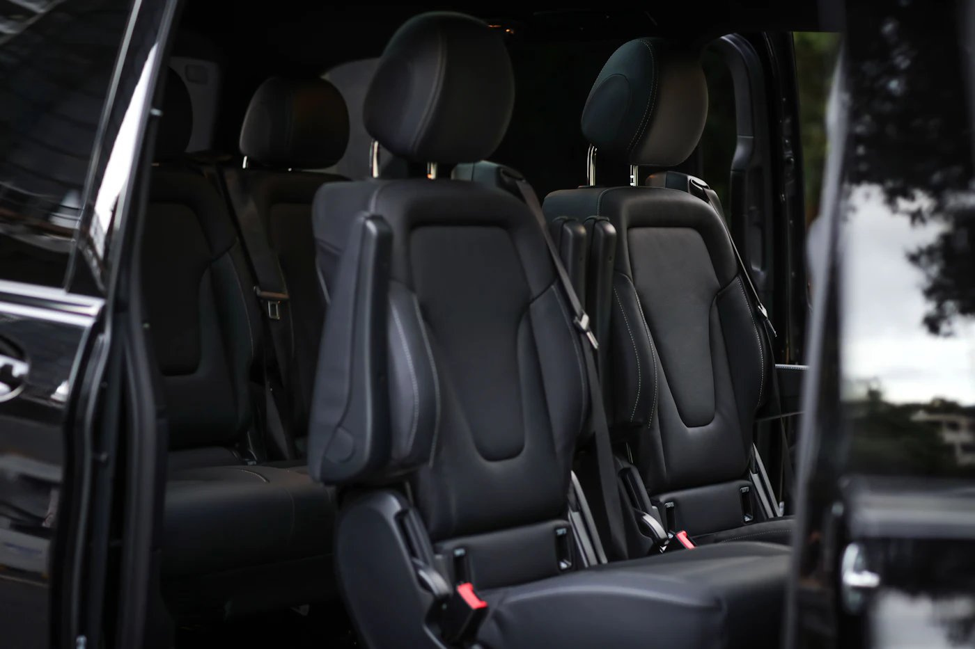 Black leather individual seats inside a Mercedes-Benz V-Class, sliding door open